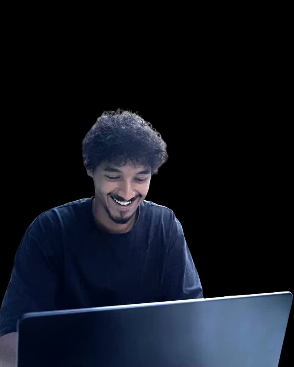 Salim Bouziane Rabhi, founder of Rabbhit, smiling while working on a laptop outdoors
